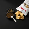 The Lil Snackie: an open PRL caviar tin with a Mother of PRL spoon and black truffle potato chips
