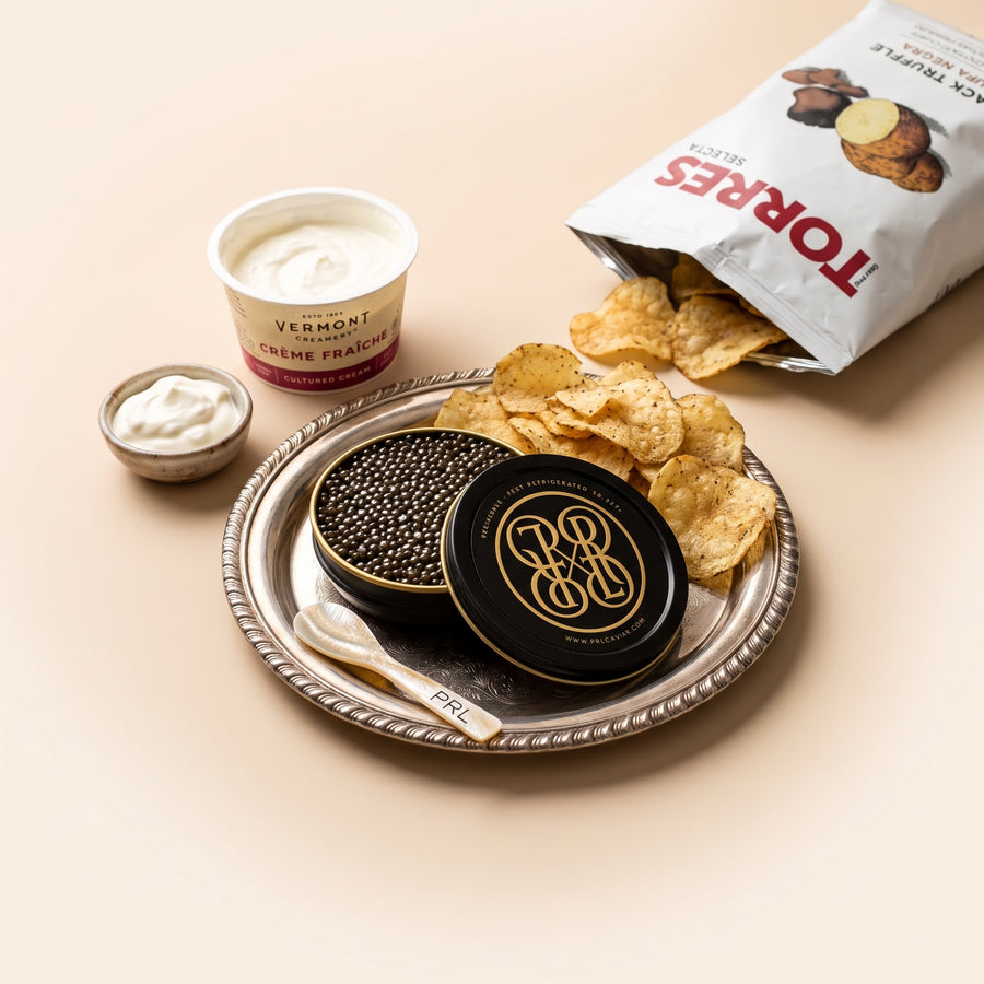 Bring the Tin Kit: PRL caviar tin on a silver tray with crème fraîche, black truffle potato chips and a pearl spoon